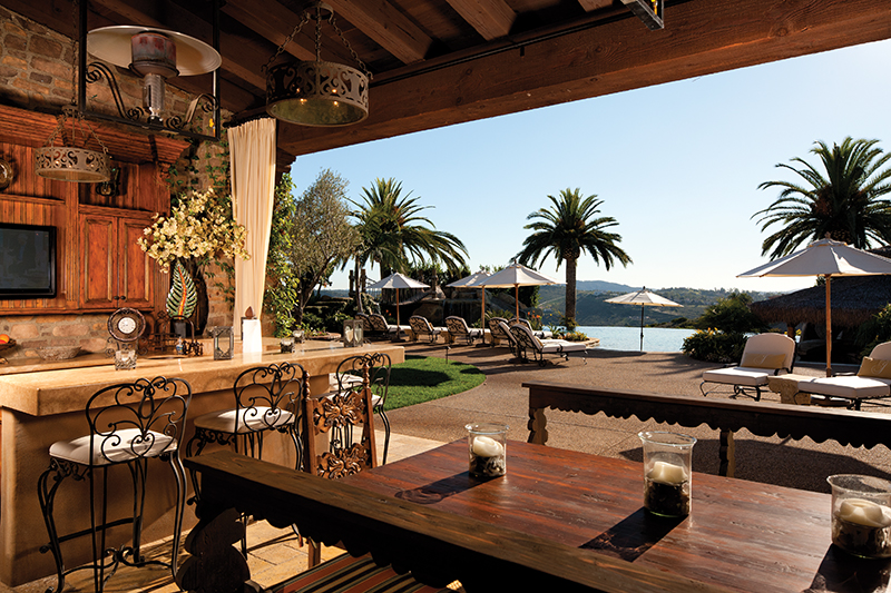The Justice family vacations in their own Cabo-style backyard and the outdoor room, overlooking the pool, has plenty of space for entertaining