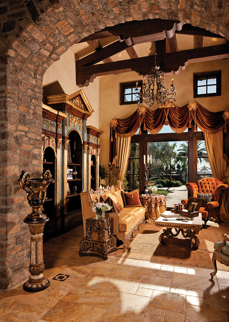 The living room has Rebecca's favorite, the hand-carved bookcase, painted blue and trimmed in red and gold leaf