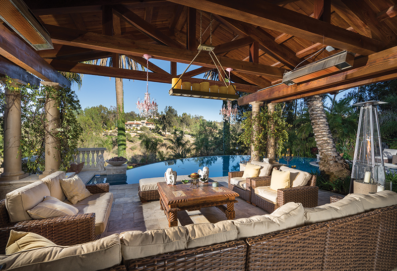 The Daneshmands love the indoor-outdoor lifestyle at their Rancho Santa Fe home where a comfortable seating area overlooks the vanishing-edge pool
